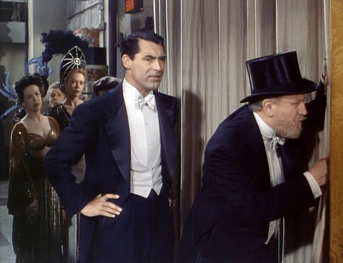 Cary Grant (as Cole Porter) and Monty Woolley (as himself) peer at the audience on opening night.