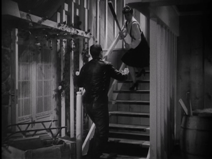 Jean Arthur fends off Cary Grant with a bat in "The Talk of the Town."